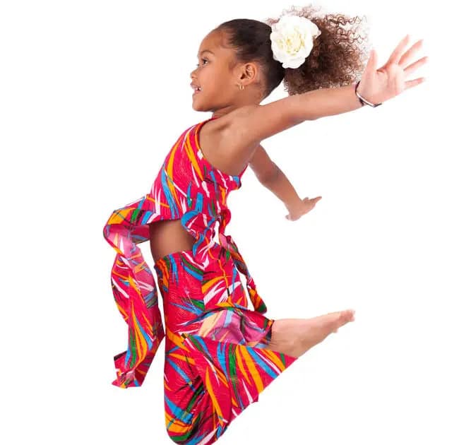 Portrait of cute Young African Asian girl jumping, over gray background